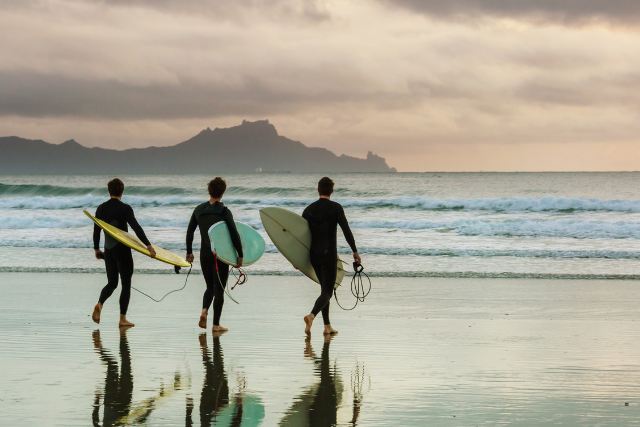 executive-surf-therapy-program Executive surf therapy programs pic shows three men at beach with surfboards